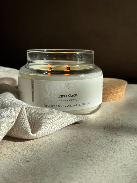 Candle with a glass lid on a textured surface